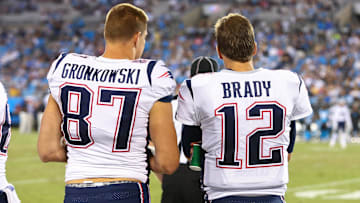 Aug 24, 2018; Charlotte, NC, USA; New England Patriots tight end Rob Gronkowski (87) talks with quarterback Tom Brady (12) during the fourth quarter against the Carolina Panthers at Bank of America Stadium. Mandatory Credit: Jeremy Brevard-Imagn Images