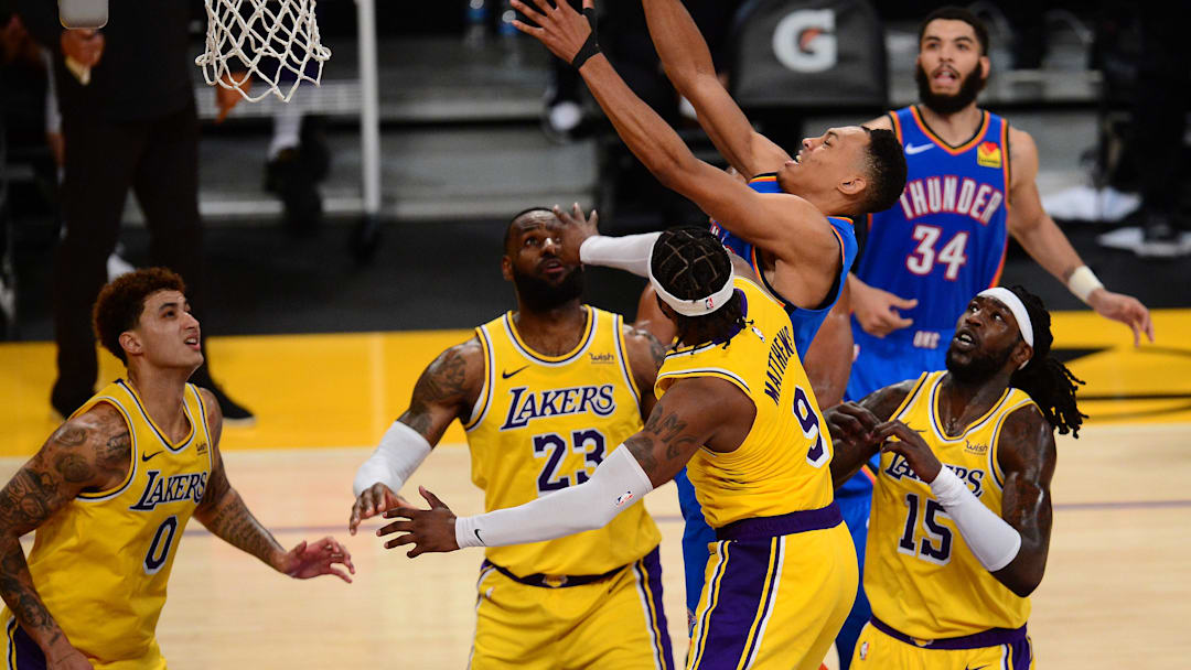 Feb 10, 2021; Los Angeles, California, USA; Oklahoma City Thunder forward Darius Bazley (7) plays for the ball against Los Angeles Lakers guard Wesley Matthews (9) forward LeBron James (23) forward Kyle Kuzma (0) and center Montrezl Harrell (15) during the second half at Staples Center. Mandatory Credit: Gary A. Vasquez-Imagn Images