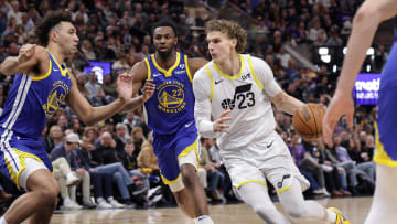 Feb 15, 2024; Salt Lake City, Utah, USA; Utah Jazz forward Lauri Markkanen (23) dribbles as Golden State Warriors forward Trayce Jackson-Davis (32) defends during the second quarter at Delta Center. Mandatory Credit: Chris Nicoll-USA TODAY Sports