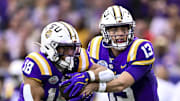 Dec 31, 2024; Houston, TX, USA; LSU Tigers quarterback Garrett Nussmeier (13) hands off the ball to running back Josh Williams (18) during the first half against the Baylor Bears at NRG Stadium. The Tigers defeat the Bears 44-31. Mandatory Credit: Maria Lysaker-Imagn Images 
