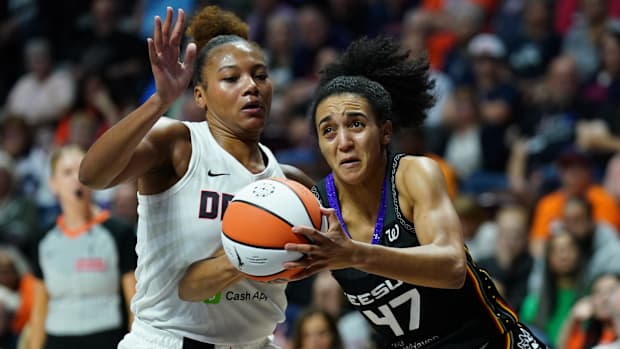Connecticut Sun guard Leila Lacan wearing a black jersey drives with the basketball in her hands