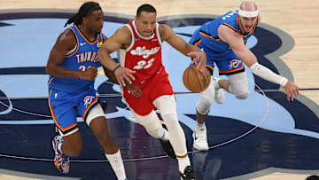 Apr 26, 2025; Memphis, Tennessee, USA; Memphis Grizzlies guard Desmond Bane (22) dribbles as Oklahoma City Thunder guard Cason Wallace (22) and guard Alex Caruso (9) defend during the second quarter during game four for the first round of the 2024 NBA Playoffs at FedExForum. Mandatory Credit: Petre Thomas-Imagn Images