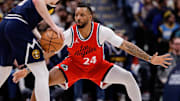 Apr 21, 2025; Denver, Colorado, USA; Denver Nuggets guard Christian Braun (0) controls the ball as Los Angeles Clippers guard Norman Powell (24) guards in the first quarter during game two of first round for the 2025 NBA Playoffs at Ball Arena. Mandatory Credit: Isaiah J. Downing-Imagn Images