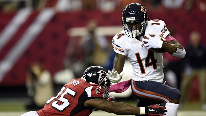 Oct 12, 2014; Atlanta, GA, USA; Chicago Bears wide receiver Santonio Holmes (14) breaks a tackle by Atlanta Falcons running back Antone Smith (35) on a punt return during the second half at the Georgia Dome. The Bears defeated the Falcons 27-13. Mandatory Credit: Dale Zanine-Imagn Images