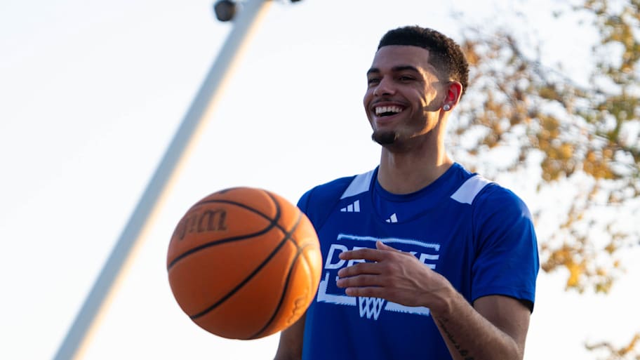 Drake’s Jalen Quinn plays basketball with kids at the Drake Hoops Fest.