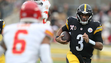Dec 25, 2024; Pittsburgh, Pennsylvania, USA;  Pittsburgh Steelers quarterback Russell Wilson (3) runs the ball as Kansas City Chiefs safety Bryan Cook (6) defends during the fourth quarter at Acrisure Stadium. Mandatory Credit: Charles LeClaire-Imagn Images