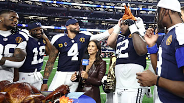 Nov 27, 2025; Arlington, Texas, USA; Dallas Cowboys quarterback Dak Prescott (4) and Dallas Cowboys guard Tyler Booker (52) celebrate with a turkey after the game against the Kansas City Chiefs at AT&T Stadium. Mandatory Credit: Kevin Jairaj-Imagn Images