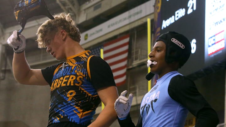 The Carroll Chargers’ Jaxx DeJean (9), left, takes off his helmet during a 7-on-7 football tournament Saturday, April 13, 2024 at the UNI Dome in Cedar Falls, Iowa.
