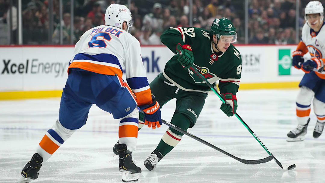 Nov 7, 2021; Saint Paul, Minnesota, USA; Minnesota Wild left wing Kirill Kaprizov (97) skates with the puck while New York Islanders defenseman Ryan Pulock (6) defends in the second period at Xcel Energy Center. Mandatory Credit: David Berding-Imagn Images