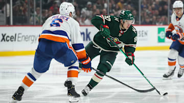 Nov 7, 2021; Saint Paul, Minnesota, USA; Minnesota Wild left wing Kirill Kaprizov (97) skates with the puck while New York Islanders defenseman Ryan Pulock (6) defends in the second period at Xcel Energy Center. Mandatory Credit: David Berding-Imagn Images