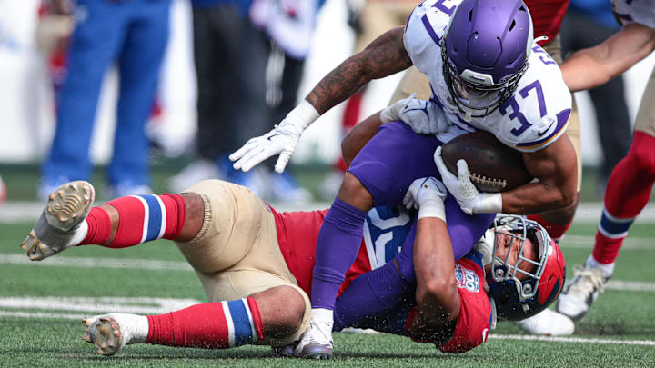 Sep 8, 2024; East Rutherford, New Jersey, USA; Minnesota Vikings running back Miles Gaskin (37) is tackled by New York Giants linebacker Darius Muasau (53) during the second half at MetLife Stadium.  