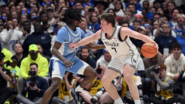 Feb 1, 2025; Durham, North Carolina, USA;  Duke basketball forward Kon Knueppel (7) pivots inside of the three-point line around UNC basketball guard Ian Jackson (11) at Cameron Indoor Stadium. 