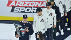 Mar 7, 2024; Tempe, Arizona, USA; Arizona Diamondbacks manager Torey Lovullo leads his team onto the ice at a Coyotes game.