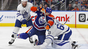 Toronto Maple Leafs defensemen Morgan Rielly (44) knocks Edmonton Oilers forward Corey Perry (90)