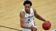 Mar 20, 2021; Indianapolis, Indiana, USA; Florida State Seminoles guard Scottie Barnes (4) dribbles the ball during the second half against the UNCG Spartans in the first round of the 2021 NCAA Tournament at Bankers Life Fieldhouse. Mandatory Credit: Kirby Lee-USA TODAY Sports