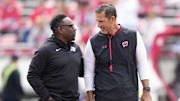 Sep 6, 2025; Madison, Wisconsin, USA; Middle Tennessee Blue Raiders head coach Derek Mason, left, and Wisconsin Badgers head coach Luke Fickell, right, talk before a game at Camp Randall Stadium.