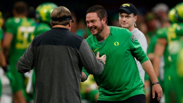 Georgia head coach Kirby Smart and Oregon head coach Dan Lanning meet during warm ups 