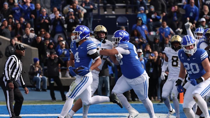 Nov 29, 2025; Provo, Utah, USA; BYU Cougars running back LJ Martin (4) runs for a touchdown against the UCF Knights during the second quarter at LaVell Edwards Stadium. Mandatory Credit: Rob Gray-Imagn Images