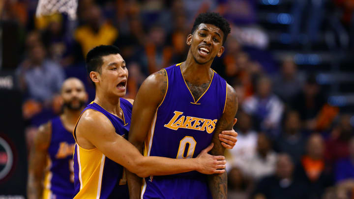 jan 19, 2015; phoenix, az, usa; los angeles lakers forward nick young (0) is restrained by guard jeremy lin as he reacts after being called for a foul in the second half against the phoenix suns at us airways center. the suns defeated the lakers 115-100. mandatory credit: mark j. rebilas-usa today sports