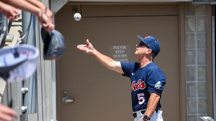 Jun 26, 2022; Omaha, NE, USA; Ole Miss Rebels head coach Mike Bianco tosses a ball to a fan before the game against the Oklahoma Sooners at Charles Schwab Field. Mandatory Credit: Steven Branscombe-Imagn Images Jun 26, 2022; Omaha, NE, USA; Ole Miss Rebels head coach Mike Bianco tosses a ball to a fan before the game against the Oklahoma Sooners at Charles Schwab Field. Mandatory Credit: Steven Branscombe-Imagn Images
