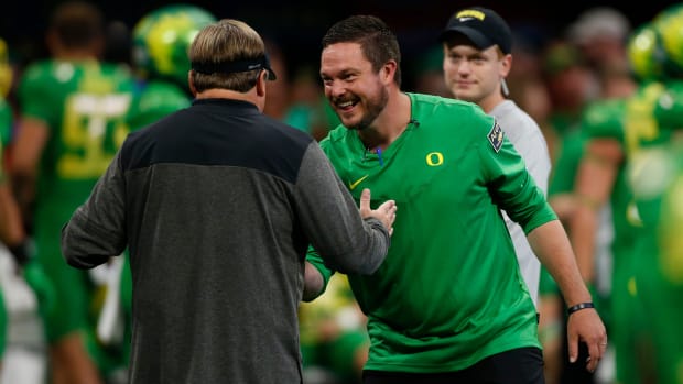 Georgia head coach Kirby Smart and Oregon head coach Dan Lanning meet during warm ups before the start of the Chick-fil-A Kic