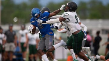 Despite a stiff arm from Barron Collier's Bryan Daniels (8), Palmetto Ridge's Khari Bendolph (3), who now plays at Naples, makes a tackle in a football game played on Sept. 2, 2022.