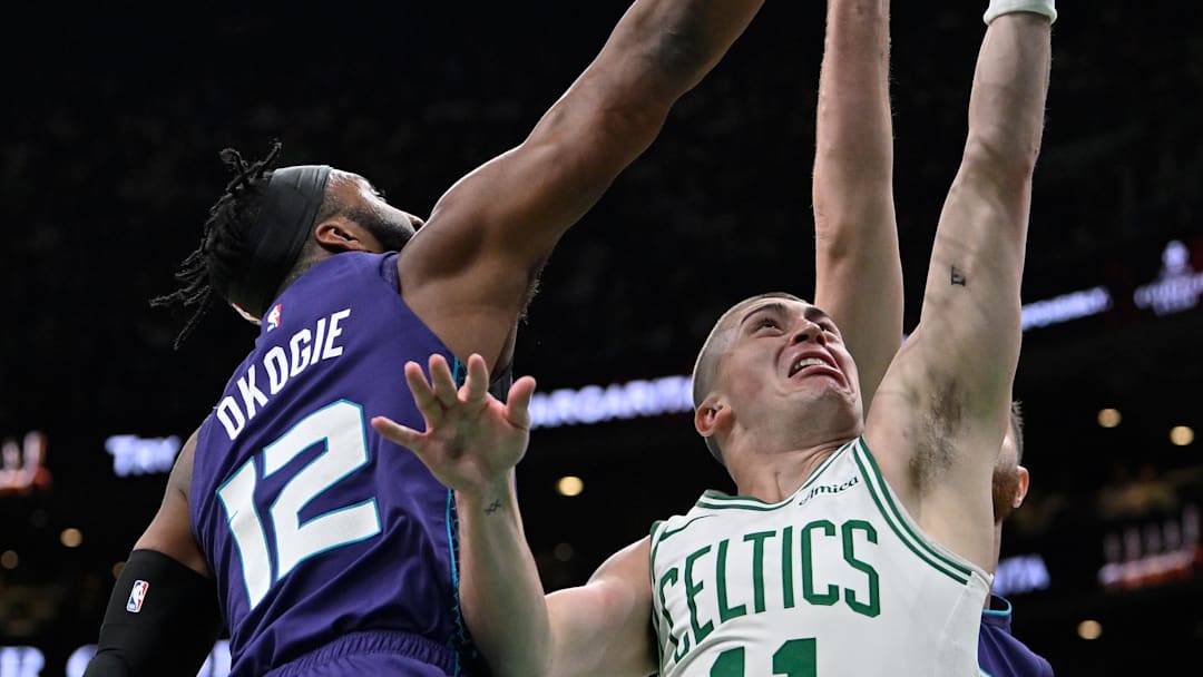 Apr 11, 2025; Boston, Massachusetts, USA; Boston Celtics guard Payton Pritchard (11) shoots against Charlotte Hornets forward Josh Okogie (12) during the first half at TD Garden. Mandatory Credit: Eric Canha-Imagn Images