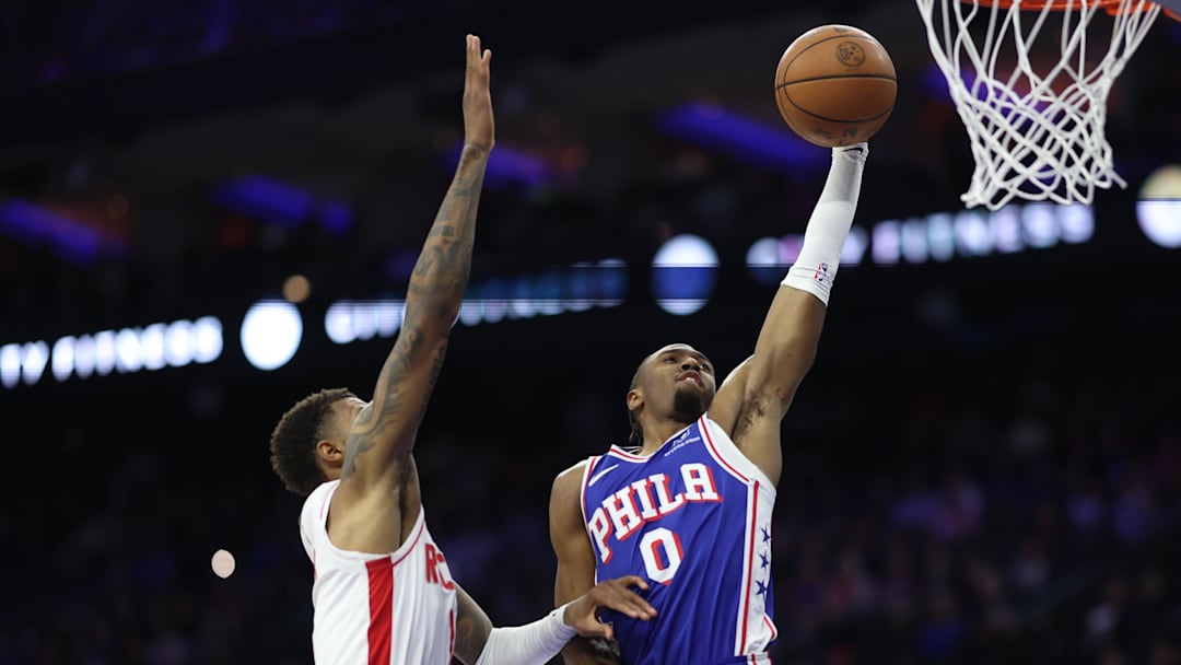 Jan 22, 2026; Philadelphia, Pennsylvania, USA; Philadelphia 76ers guard Tyrese Maxey (0) drives for a dunk against Houston Rockets forward Jabari Smith Jr. (10) during the second quarter at Xfinity Mobile Arena. Mandatory Credit: Bill Streicher-Imagn Images