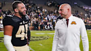 Purdue Boilermakers running back Devin Mockobee (45) talks with Minnesota Golden Gophers head coach P.J. Fleck
