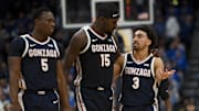 Gonzaga Bulldogs forward Emmanuel Innocenti (5), forward Graham Ike (15), and guard Braeden Smith (3) walk back to the bench against the Kentucky Wildcats during the first half at Bridgestone Arena.