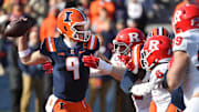 Nov 1, 2025; Champaign, Illinois, USA;  Illinois Fighting Illini quarterback Luke Altmyer (9) passes over the Rutgers Scarlet Knights line during the first half at Memorial Stadium. Mandatory Credit: Ron Johnson-Imagn Images