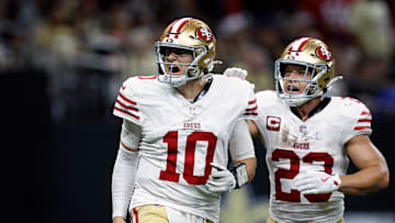 San Francisco 49ers quarterback Mac Jones (10) and running back Christian McCaffrey (23)
