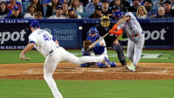 Oct 20, 2024; Los Angeles, California, USA; New York Mets catcher Francisco Alvarez (4) hits an RBI sacrifice fly during the seventh inning against the Los Angeles Dodgers during game six of the NLCS for the 2024 MLB playoffs at Dodger Stadium. Mandatory Credit: Jason Parkhurst-Imagn Images