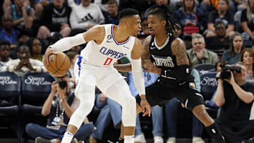 Mar 31, 2023; Memphis, Tennessee, USA; Los Angeles Clippers guard Russell Westbrook (0) dribbles as Memphis Grizzlies guard Ja Morant (12) defends during the first half at FedExForum. Mandatory Credit: Petre Thomas-Imagn Images