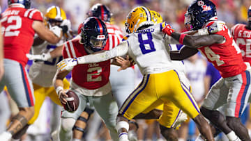 Oct 12, 2024; Baton Rouge, Louisiana, USA;  Mississippi Rebels quarterback Jaxson Dart (2) is sacked by LSU Tigers safety Major Burns (8) during the second half at Tiger Stadium. Mandatory Credit: Stephen Lew-Imagn Images