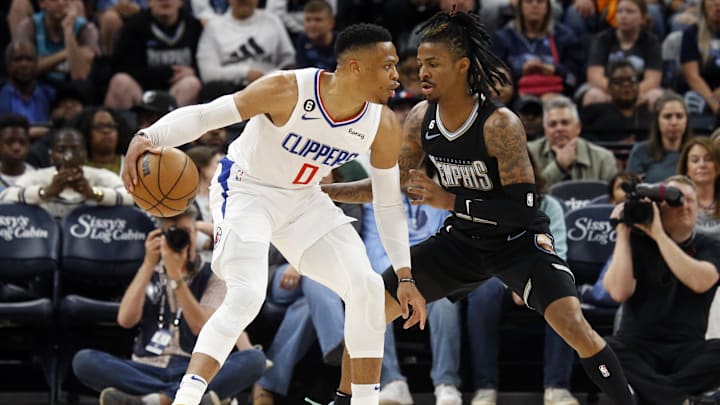 Mar 31, 2023; Memphis, Tennessee, USA; Los Angeles Clippers guard Russell Westbrook (0) dribbles as Memphis Grizzlies guard Ja Morant (12) defends during the first half at FedExForum. Mandatory Credit: Petre Thomas-Imagn Images