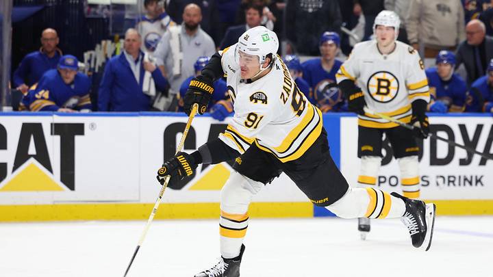 Apr 19, 2026; Buffalo, New York, USA; Boston Bruins defenseman Nikita Zadorov (91) takes a shot on goal during the third period against the Buffalo Sabres in game one of the first round of the 2026 Stanley Cup Playoffs at KeyBank Center. Mandatory Credit: Timothy T. Ludwig-Imagn Images