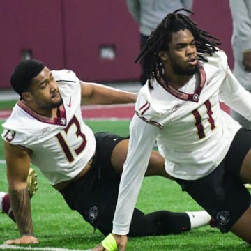 Florida State football players Sione Lolohea (13) and Patrick Payton (11) take part in the final Tour of Duty winter workouts ahead of 2024 spring practices on Thursday, March 7, 2024.