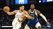 Nov 4, 2025; San Francisco, California, USA; Phoenix Suns guard Devin Booker (1) drives to the basket against Golden State Warriors forward Jonathan Kuminga (1) in the second quarter at Chase Center. Mandatory Credit: Eakin Howard-Imagn Images