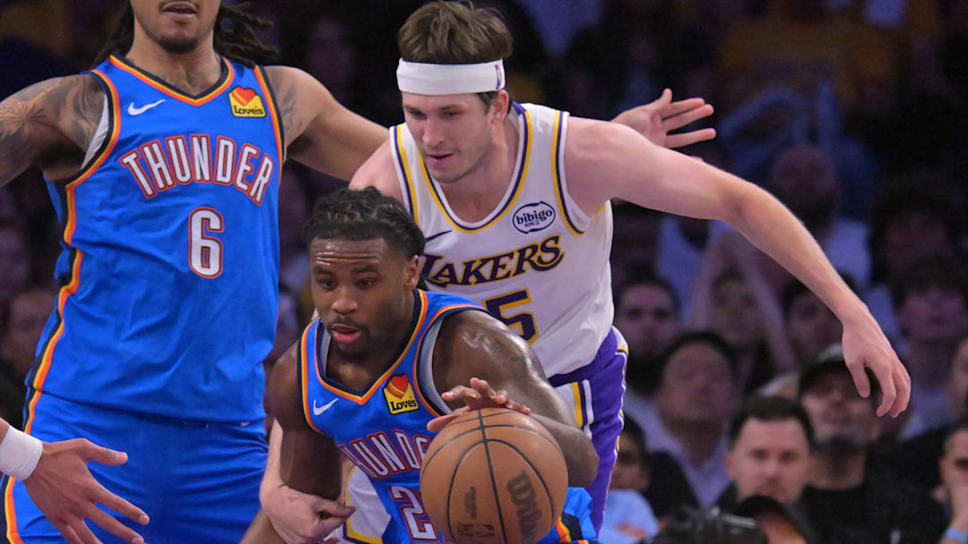 May 9, 2026; Los Angeles, California, USA; Oklahoma City Thunder guard Cason Wallace (22) steals the ball from Los Angeles Lakers guard Austin Reaves (15) in the second half of game three of the second round of the 2026 NBA Playoffs at Crypto.com Arena. Mandatory Credit: Jayne Kamin-Oncea-Imagn Images
