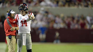 Sep 28, 2013; Tuscaloosa, AL, USA; Mississippi Rebels head coach Hugh Freeze talks with quarterback Bo Wallace (14) during a timeout against the Alabama Crimson Tide in the third quarter at Bryant-Denny Stadium. The Alabama Crimson Tide defeated the Mississippi Rebels 25-0. Mandatory Credit: John David Mercer-Imagn Images