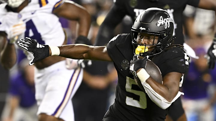Oct 26, 2024; College Station, Texas, USA; Texas A&M Aggies running back Amari Daniels (5) runs the ball against the LSU Tigers during the fourth quarter. The Aggies defeated the Tigers 38-23; at Kyle Field. Mandatory Credit: Maria Lysaker-Imagn Images.  