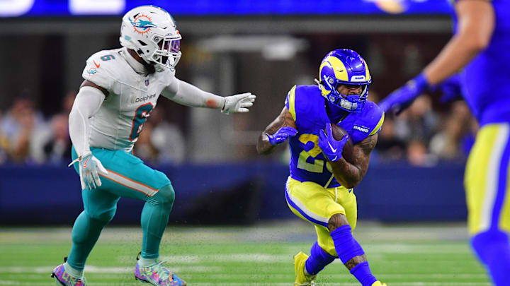 Los Angeles Rams running back Kyren Williams (23) runs the ball Miami Dolphins linebacker Anthony Walker Jr. (6) during the first half at SoFi Stadium.