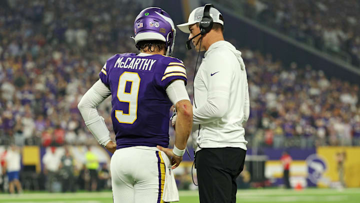 Sep 14, 2025; Minneapolis, Minnesota, USA; Minnesota Vikings quarterback J.J. McCarthy (9) speaks with Minnesota Vikings head coach Kevin O'Connell during the first half against the Atlanta Falcons at U.S. Bank Stadium. Mandatory Credit: Matt Krohn-Imagn Images
