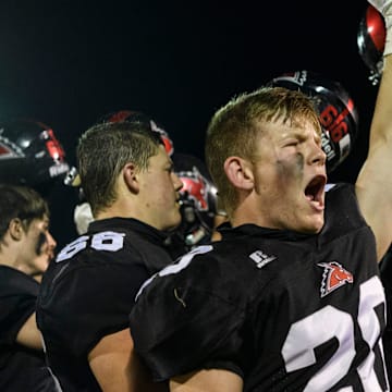 Fairfield's McGwire Taylor (20) and his teammates sing the school fight song for the fans as they celebrate their 17-0 victory over the Eldorado Eagles in their last game of the season at Fairfield Community High School in Fairfield, Ill., Friday, April 23, 2021.

9 Illinois Football