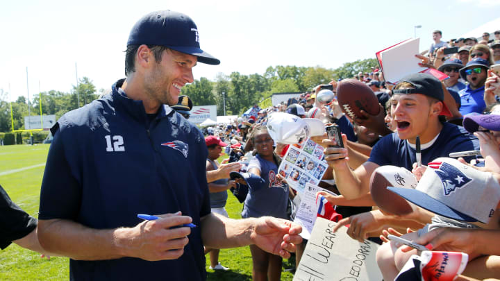 Tom Brady signs an autograph