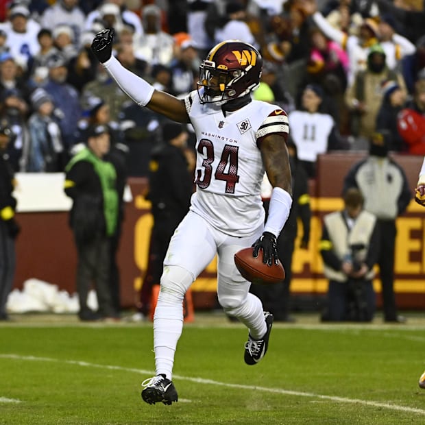 Washington Commanders cornerback Christian Holmes reacts after recovering a fumble 