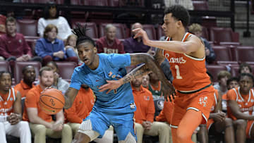 Feb 19, 2025; Tallahassee, Florida, USA; Florida State Seminoles forward Jamir Watkins (1) drives to the net past Miami Hurricanes center Lynn Kidd (1) during the first half at Donald L. Tucker Center. Mandatory Credit: Melina Myers-Imagn Images