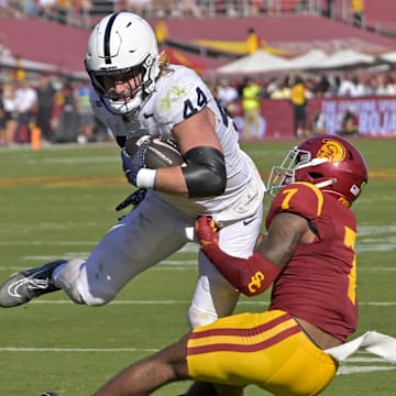 Penn State Nittany Lions tight end Tyler Warren (44) is stopped by USC Trojans safety Kamari Ramsey (7) after a short gain in the second half at United Airlines Field at the Los Angeles Memorial Coliseum.