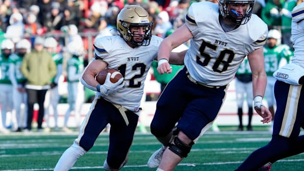Alexander Orecchio (12) gets help from his Old Tappan teammate, Jack Horgan (58), just before scoring a touchdown in the thir
